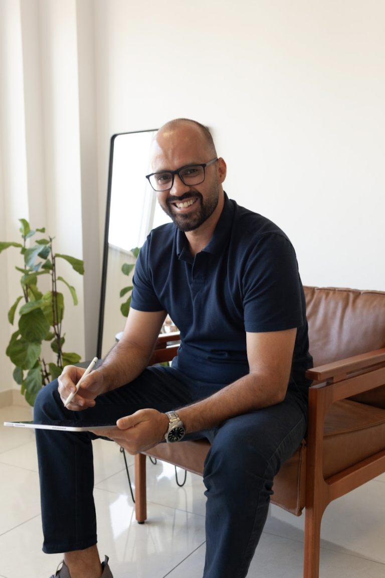 Imagem do André Teixeira em uma cadeira com um tablet